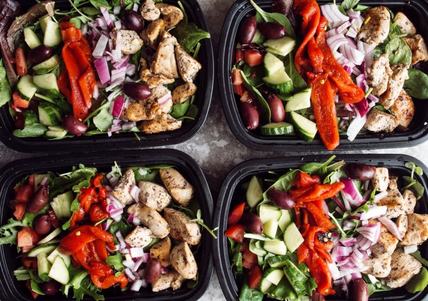 Healthy meal prep chicken salad with tomato cucumber red pepper and onion